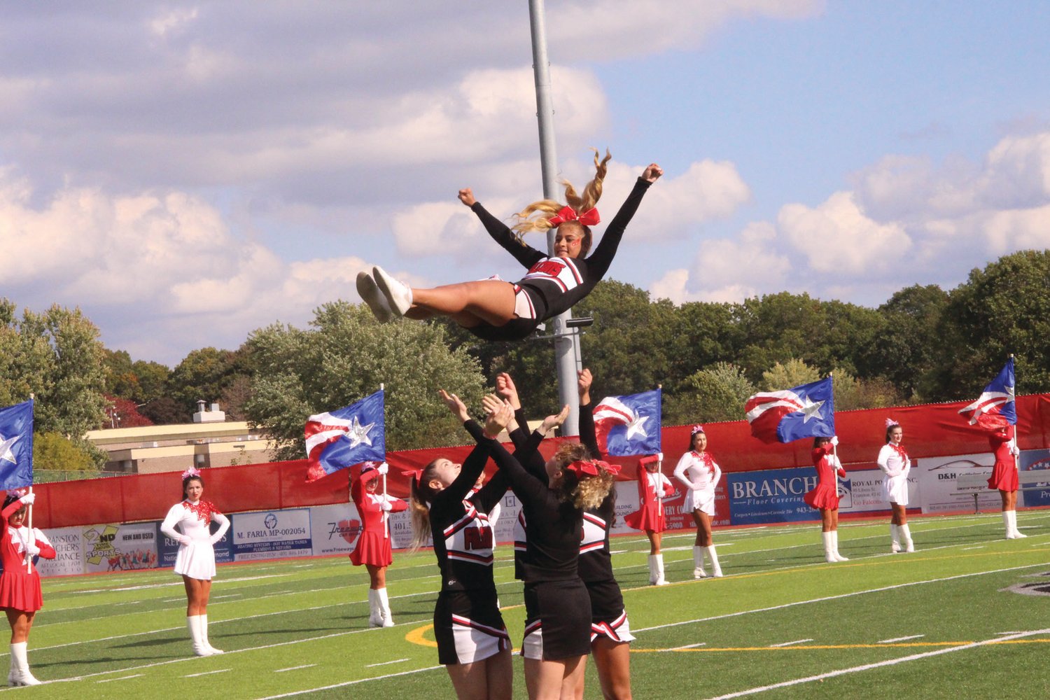 FLYING HIGH: The Cranston High School West Falconettes, Westernettes and cheerleaders entertain the crowd during the school’s Oct. 22 homecoming.